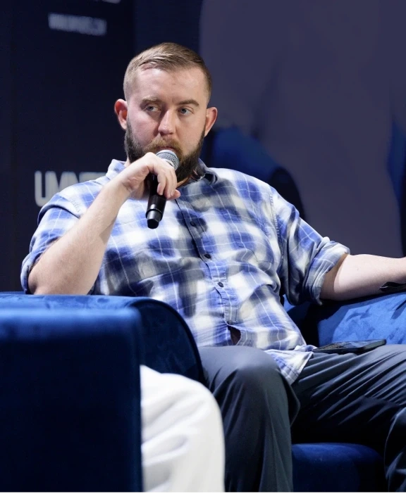 A panelist speaking into a microphone